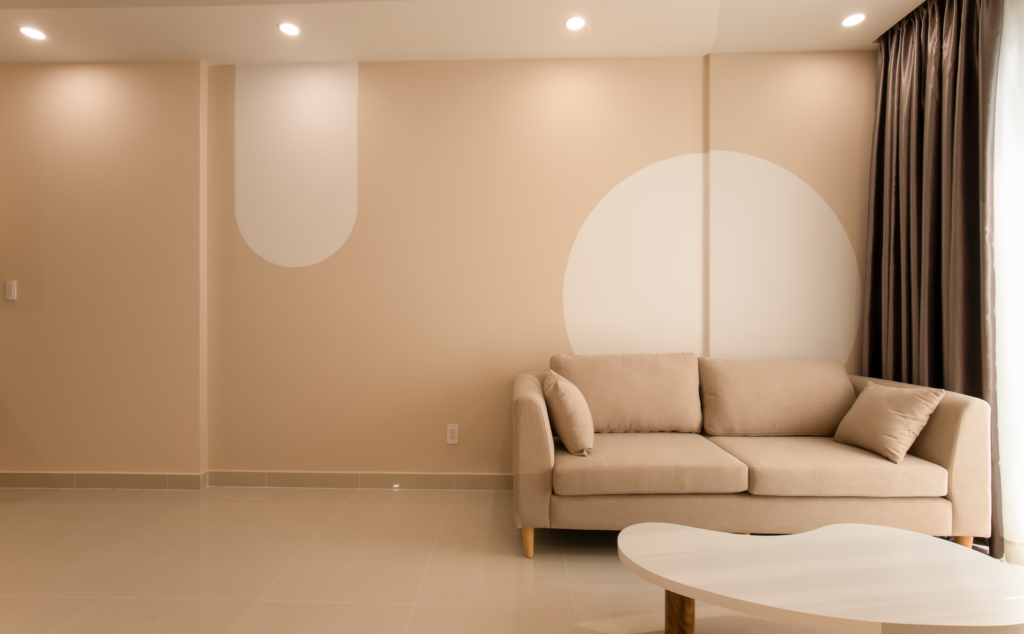 Uncluttered living room with a beige sofa and a low white table